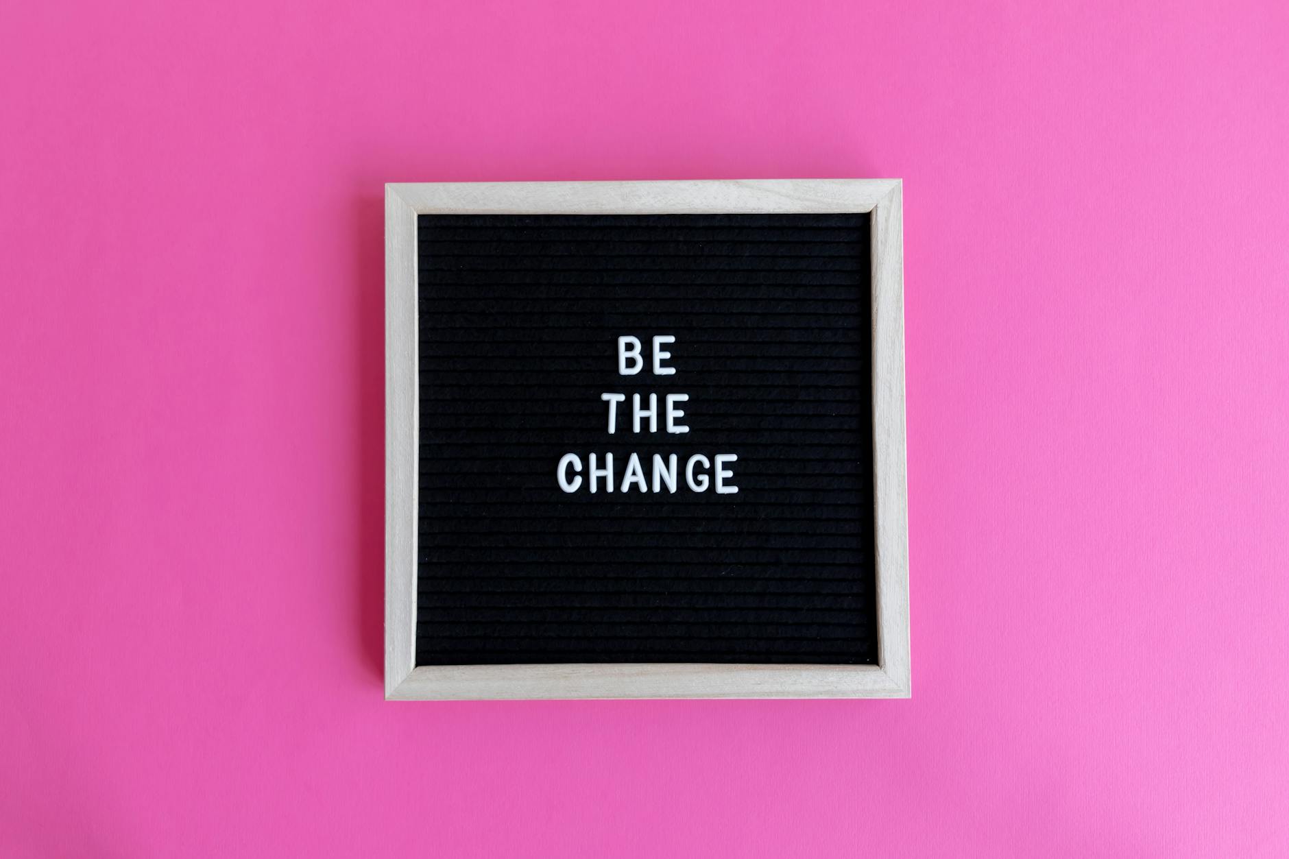 inspirational words in frame on pink background